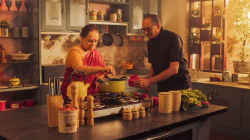 Elderly couples cooking together in a kitchen represent safe home kitchen accessibility.